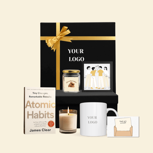Corporate gift hamper with Atomic Habits book, mug, cookie jar, candle, artwork, and thank-you car