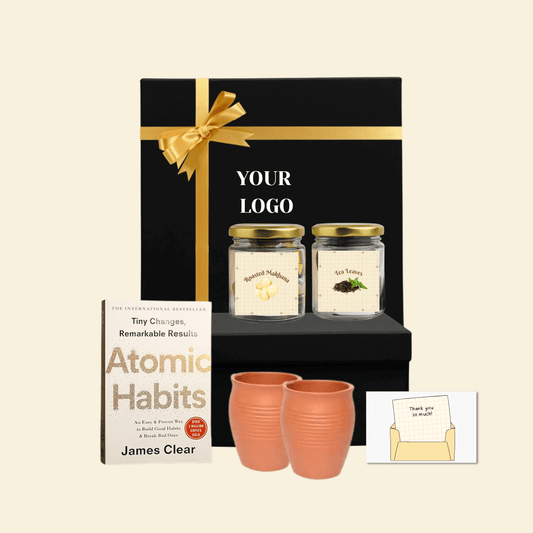 Corporate gift box with roasted makhana, tea leaves, clay cups, book and thank you card