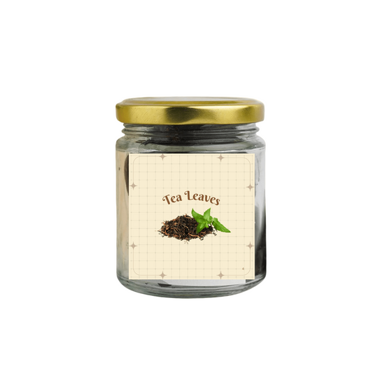 Jar of tea leaves with a gold lid on a beige background