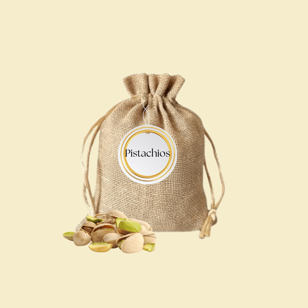 A small jute pouch filled with pistachios, labeled with a round white and gold tag.
